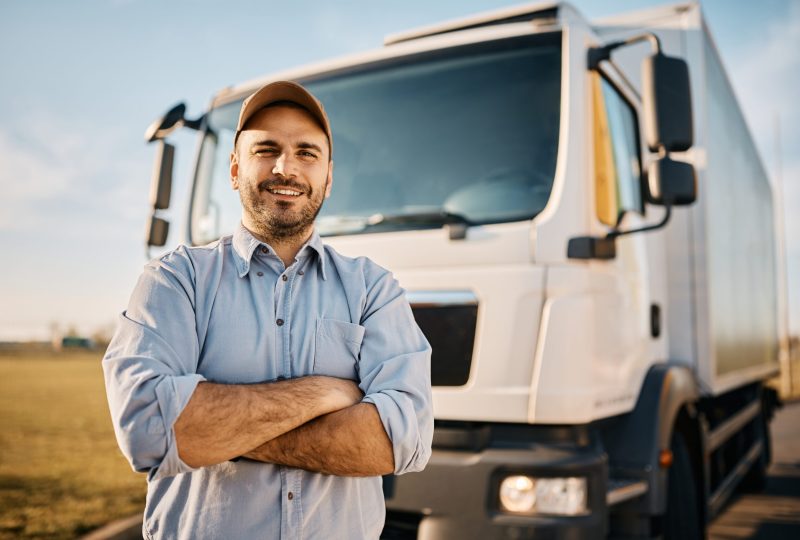 Happy,Confident,Male,Driver,Standing,In,Front,On,His,Truck